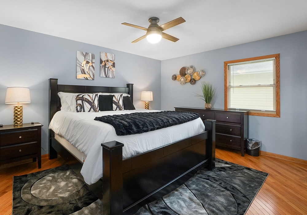 a large bed in a room of a corporate hom rental